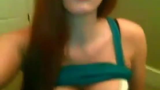 Busty redhead with glasses teasing